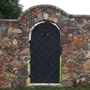 img.: Stone fence with a gate